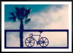 Gallery wall with picture frame in black in size 50x70 with print "Bicycle in front of sky"