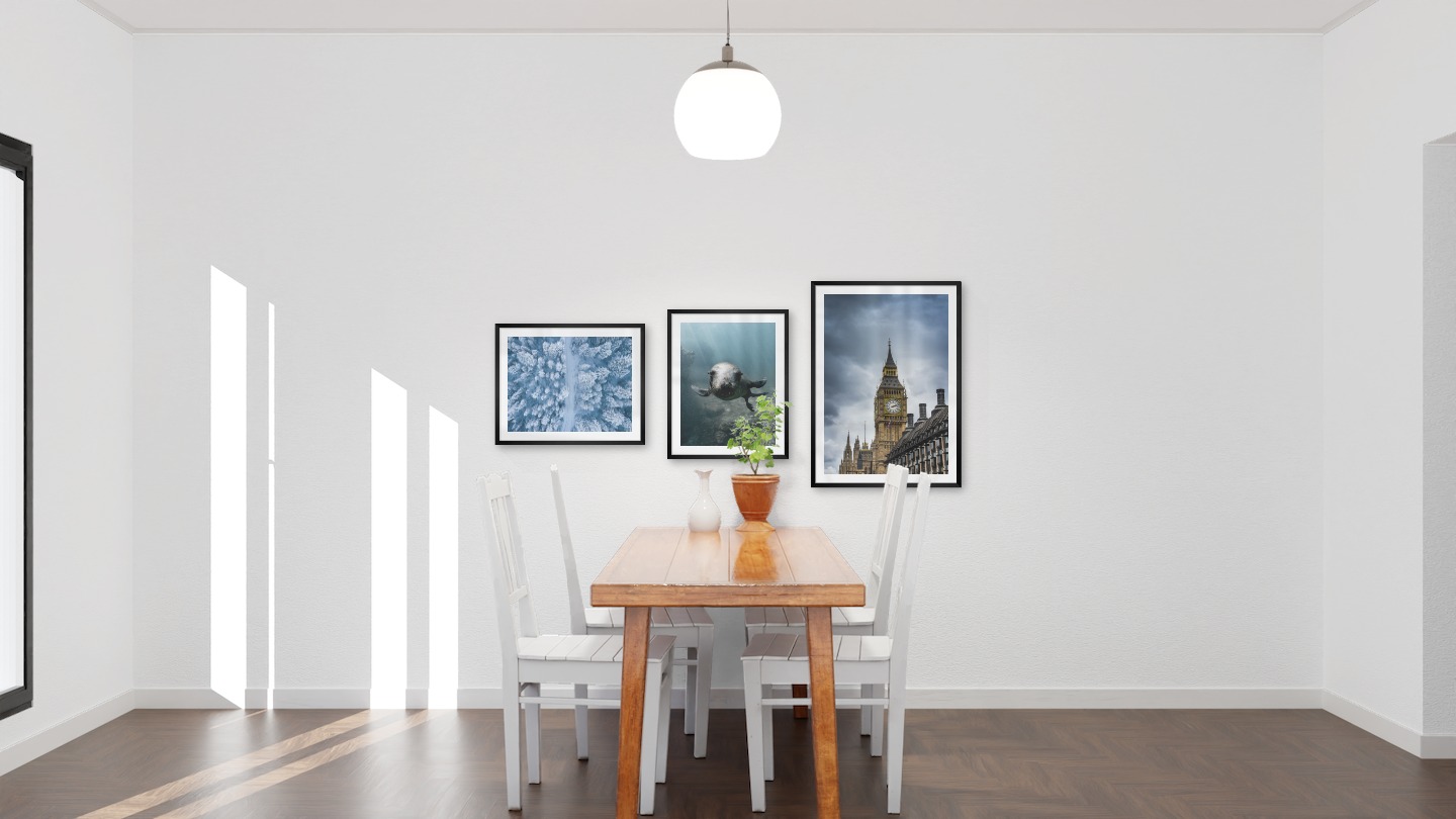 Gallery wall with picture frames in black in sizes 40x50 and 50x70 with prints "Winter road from above", "Seal in the water" and "Big Ben in London"