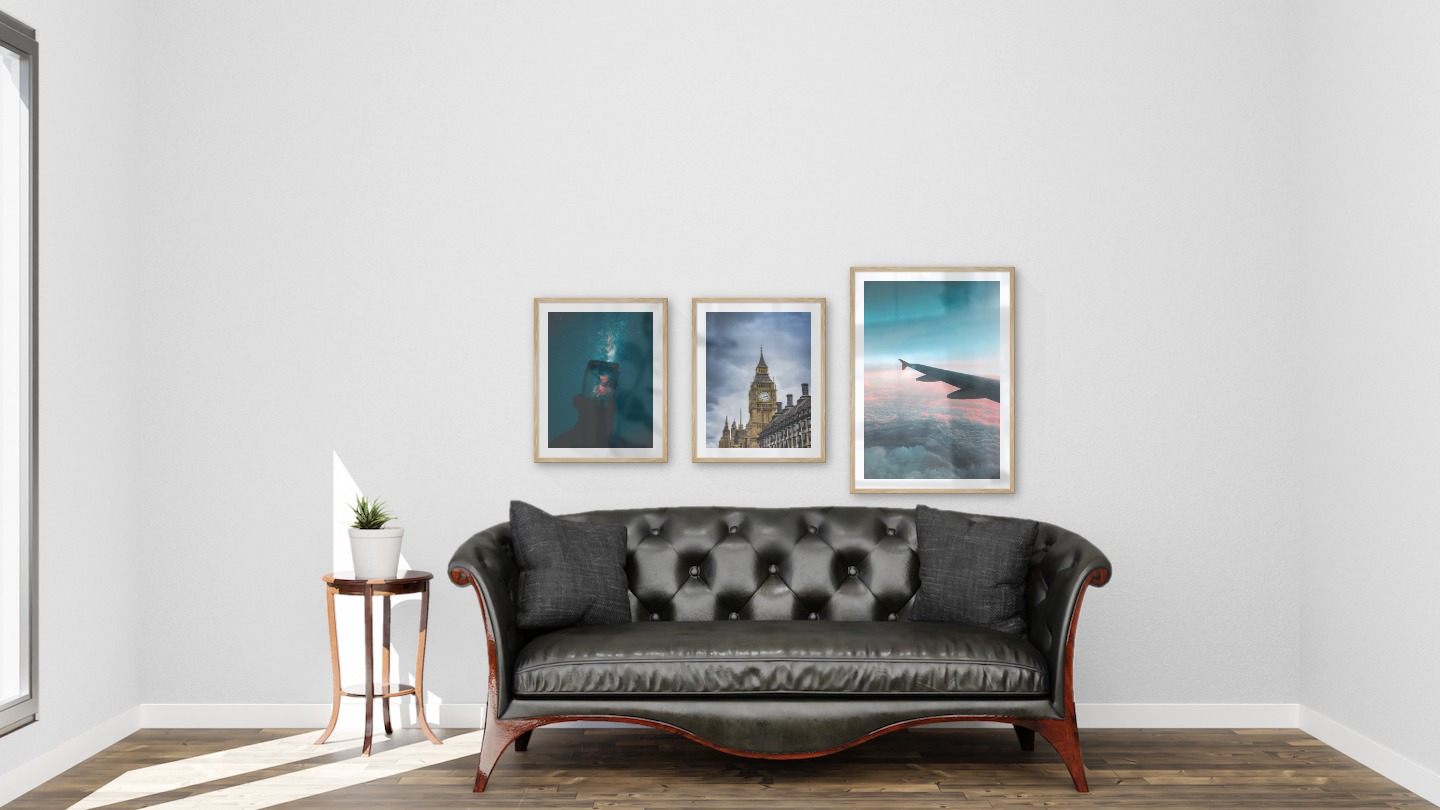 Gallery wall with picture frames in wood in sizes 40x50 and 50x70 with prints "Jar in front of space", "Big Ben in London" and "Above the clouds"