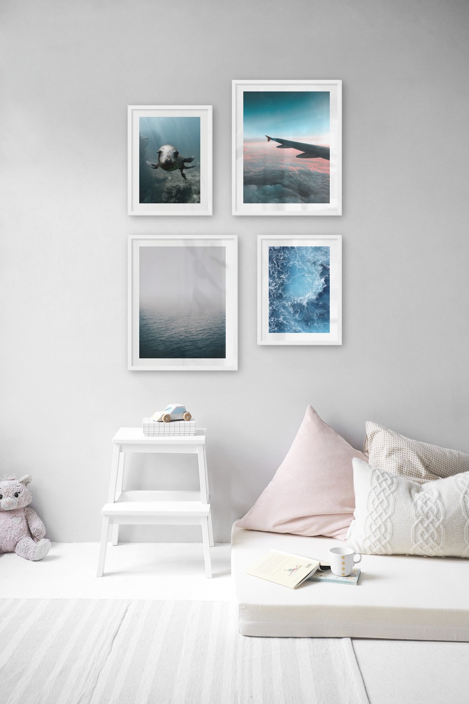 Gallery wall with picture frames in white in sizes 30x40 and 40x50 with prints "Seal in the water", "Above the clouds", "Fog over the sea" and "Sea from above"