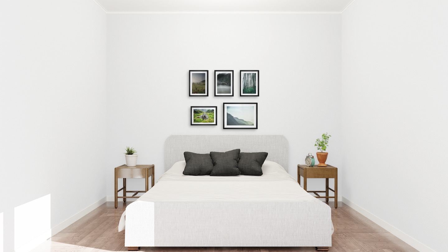 Gallery wall with picture frames in black in sizes 21x30 and 30x40 with prints "Field with cottage", "Train over bridge", "Tall trees", "Zebror" and "Foggy mountain"