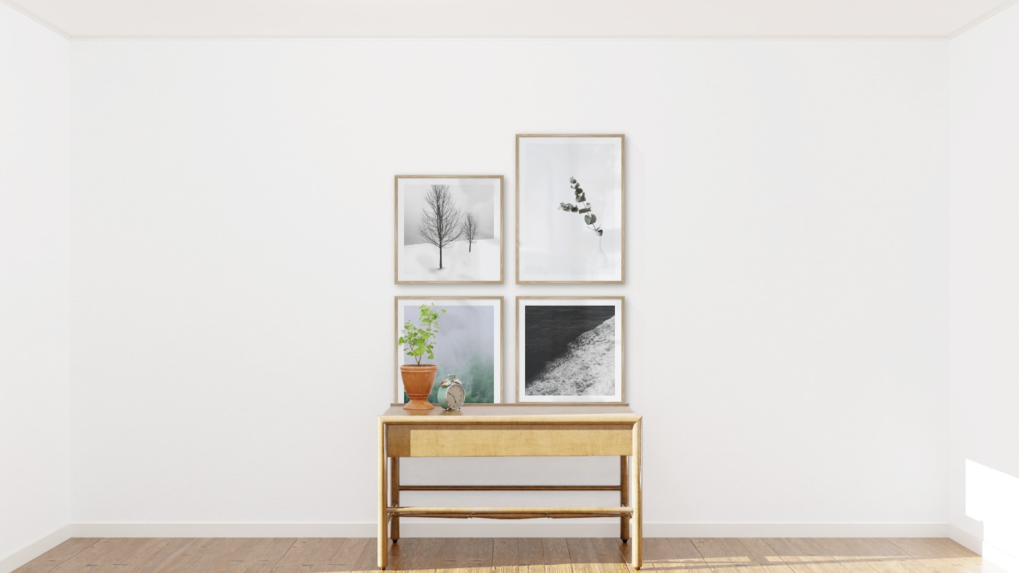 Gallery wall with picture frames in wood in sizes 50x50 and 50x70 with prints "Trees in the snow", "Branch in vase", "Slope with trees" and "Swell from waves"