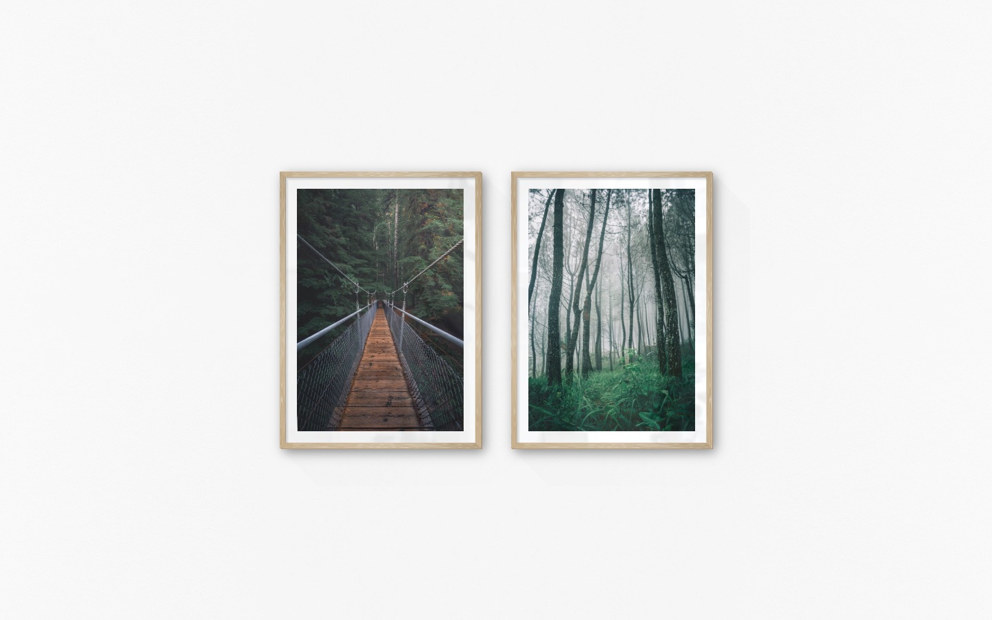 Gallery wall with picture frames in wood in sizes 50x70 with prints "Bridge in the woods" and "Tall trees"
