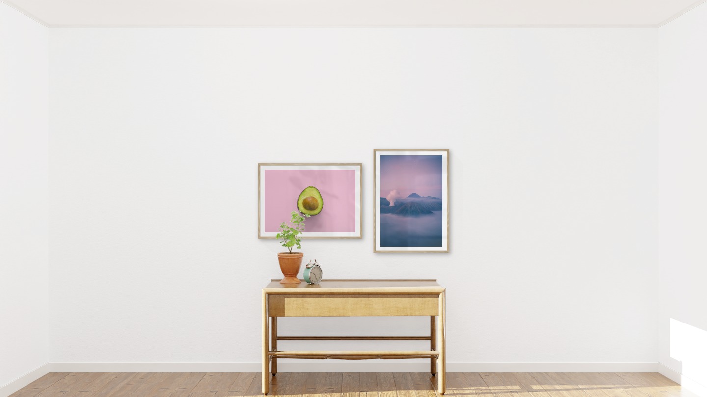Gallery wall with picture frames in wood in sizes 50x70 with prints "Avocado" and "Mountains above the clouds"