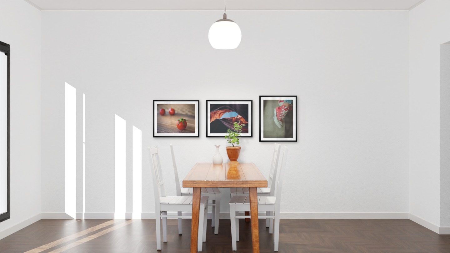 Gallery wall with picture frames in black in sizes 40x50 with prints "Tomatoes", "Red rock formations" and "Red shoes"