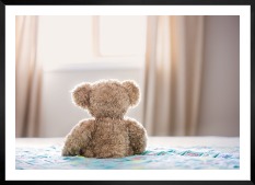 Gallery wall with picture frame in black in size 50x70 with print "Teddy bear in front of window"