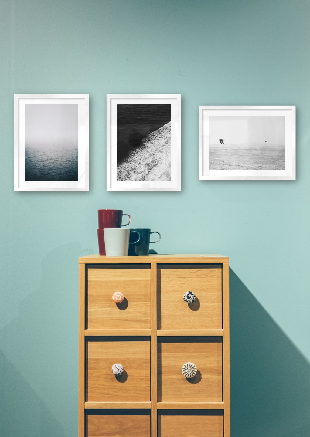Gallery wall with picture frames in silver in sizes 30x40 with prints "Fog over the sea", "Swell from waves" and "Birds over the sea"