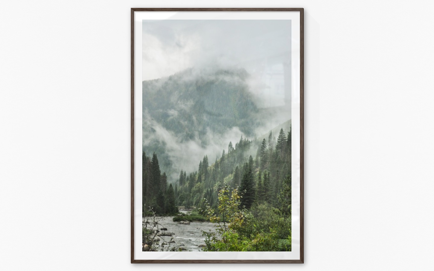 Gallery wall with picture frame in dark wood in size 100x150 with print "River in front of mountains"