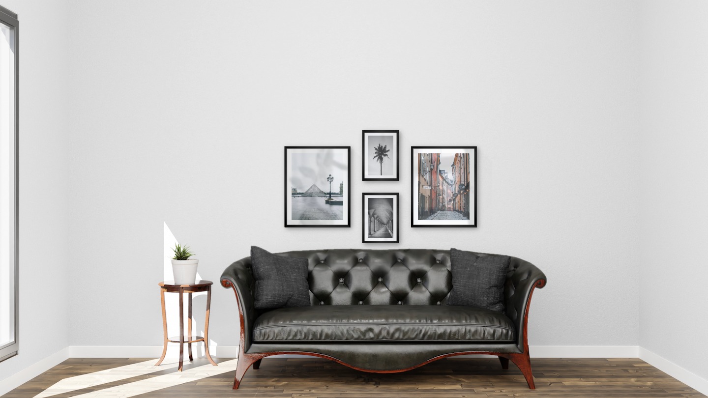 Gallery wall with picture frames in black in sizes 40x50 and 21x30 with prints "Louvre in Paris", "Hallway with pillars and arches", "Palm" and "Old town in Stockholm"