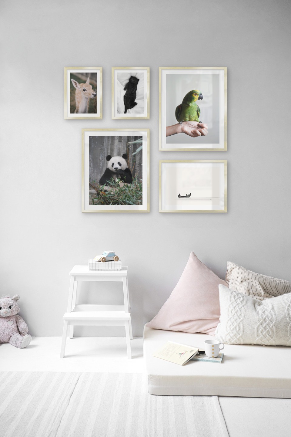 Gallery wall with picture frames in gold in sizes 21x30, 40x50 and 30x40 with prints "Cat in bed", "Deer", "Panda", "Green parrot" and "People in boat"