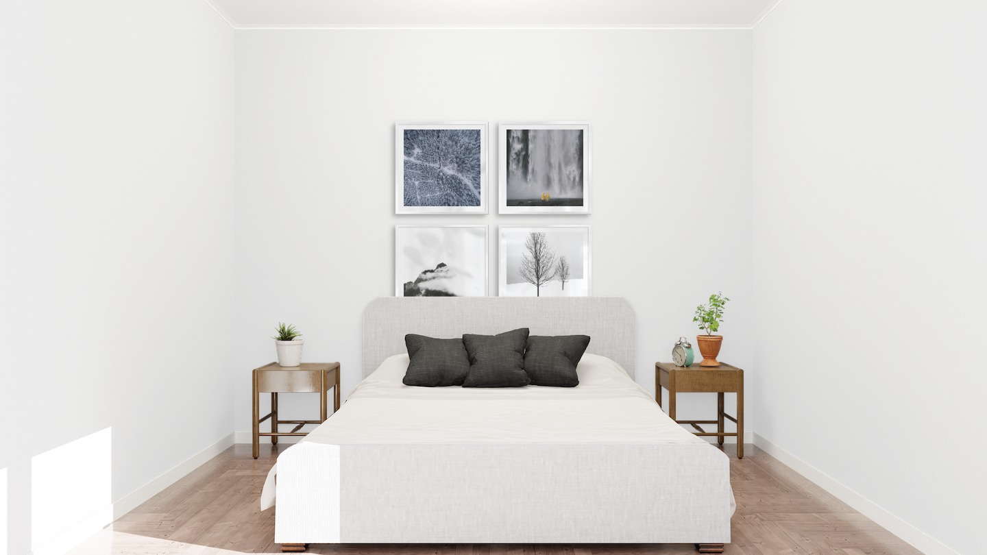 Gallery wall with picture frames in silver in sizes 50x50 with prints "Snowy treetops", "Waterfall with people", "Mountain peaks in fog" and "Trees in the snow"