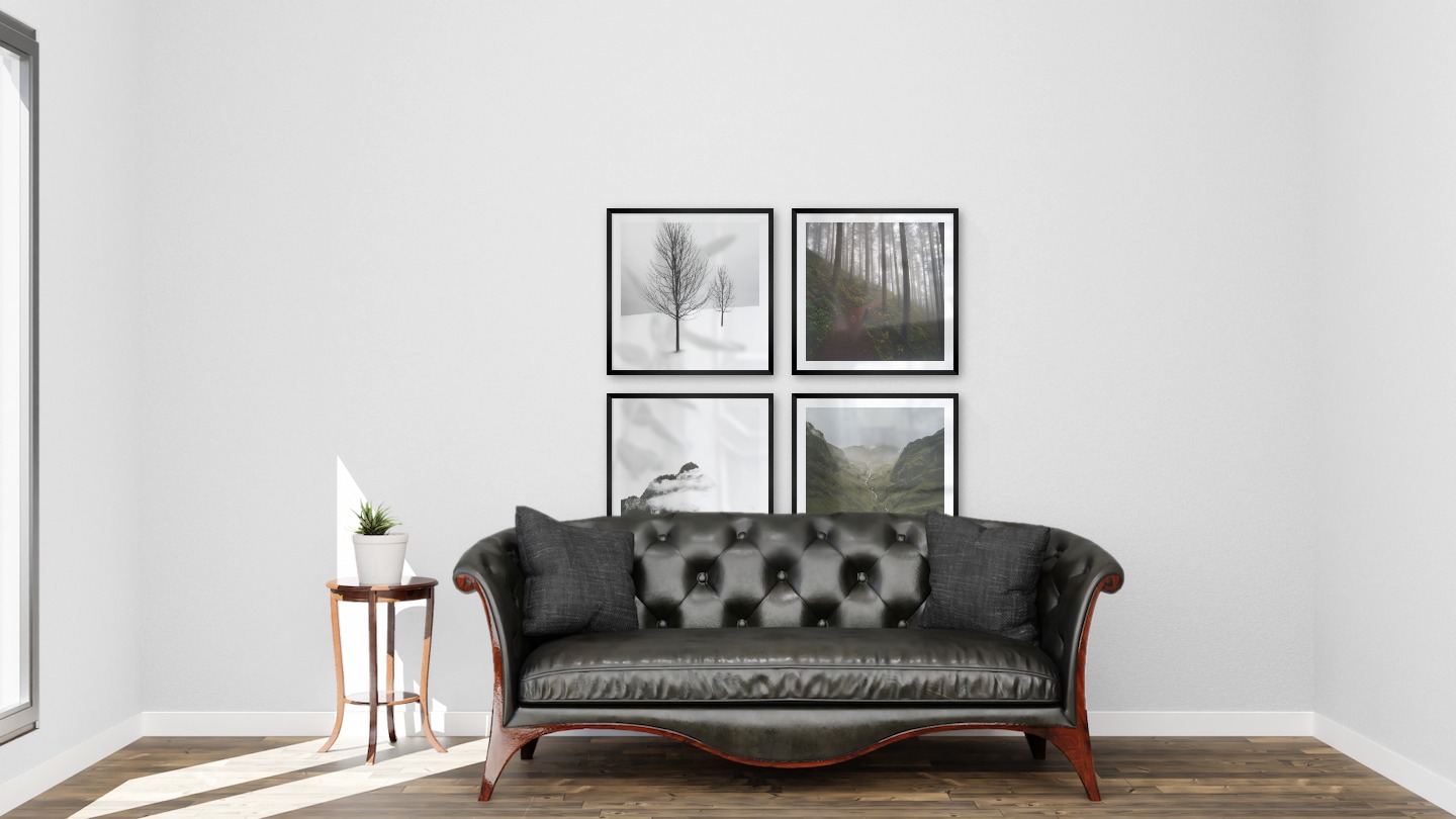 Gallery wall with picture frames in black in sizes 50x50 with prints "Trees in the snow", "Forest road", "Mountain peaks in fog" and "Stream in valley"