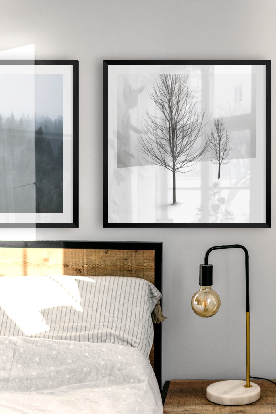 Gallery wall with picture frames in black in sizes 50x50 with prints "Foggy forest" and "Trees in the snow"