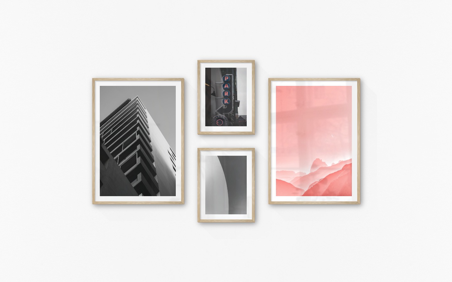 Gallery wall with picture frames in wood in sizes 50x70 and 30x40 with prints "Black and white building", "Sign "Park"", "Line" and "Pink sky"