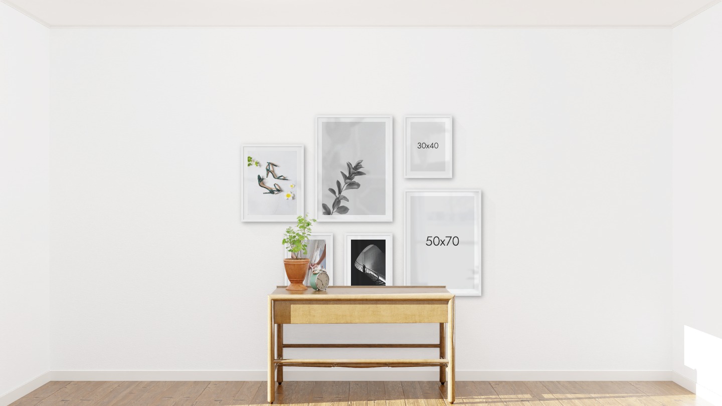 Gallery wall with picture frames in white in sizes 40x50, 50x70 and 30x40 with prints "Heels", "Twig", "Dress with waistband" and "Staircase"