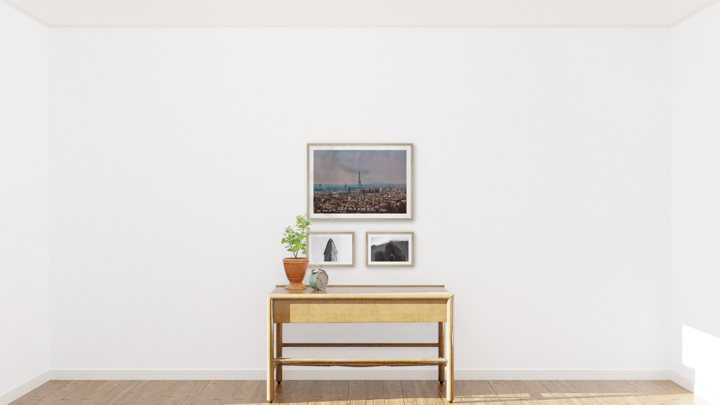 Gallery wall with picture frames in wood in sizes 50x70 and 21x30 with prints "Eifel Tower in Paris", "Triangular building" and "Icelandic horses"