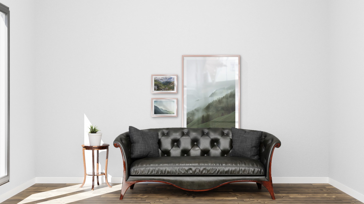 Gallery wall with picture frames in copper in sizes 21x30 and 70x100 with prints "Bergsdal", "Foggy mountain" and "Foggy slope"