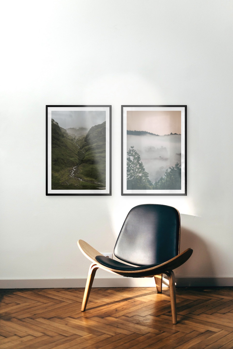 Gallery wall with picture frames in black in sizes 50x70 with prints "Stream in valley" and "Wooden tops and orange sky"