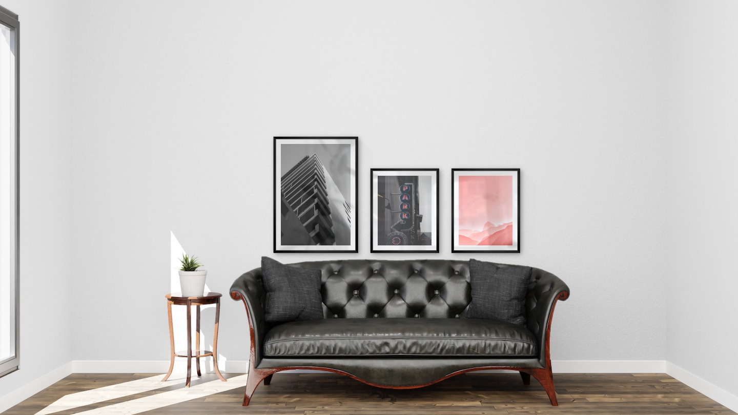 Gallery wall with picture frames in black in sizes 50x70 and 40x50 with prints "Black and white building", "Sign "Park"" and "Pink sky"
