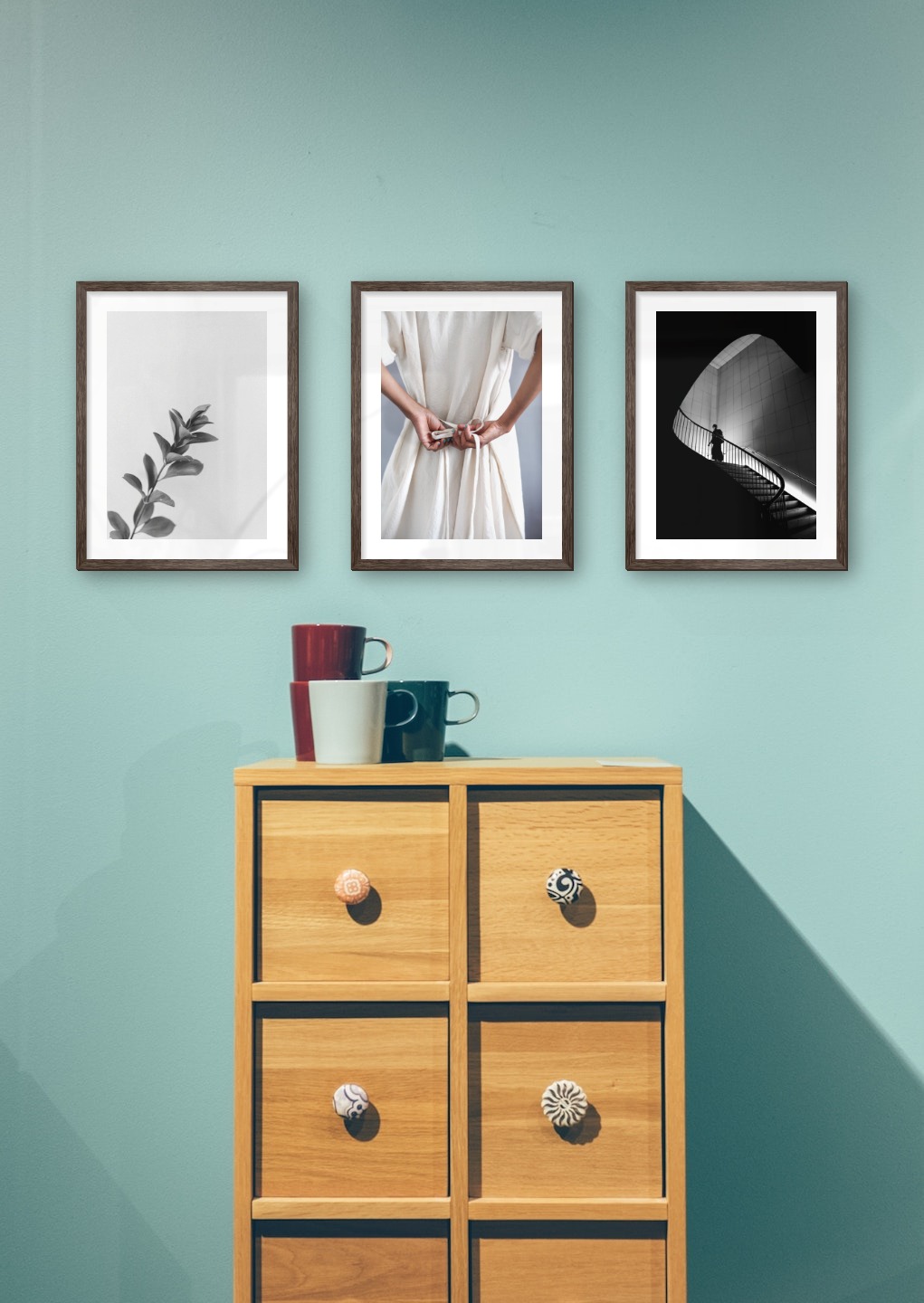 Gallery wall with picture frames in dark wood in sizes 30x40 with prints "Twig", "Dress with waistband" and "Staircase"