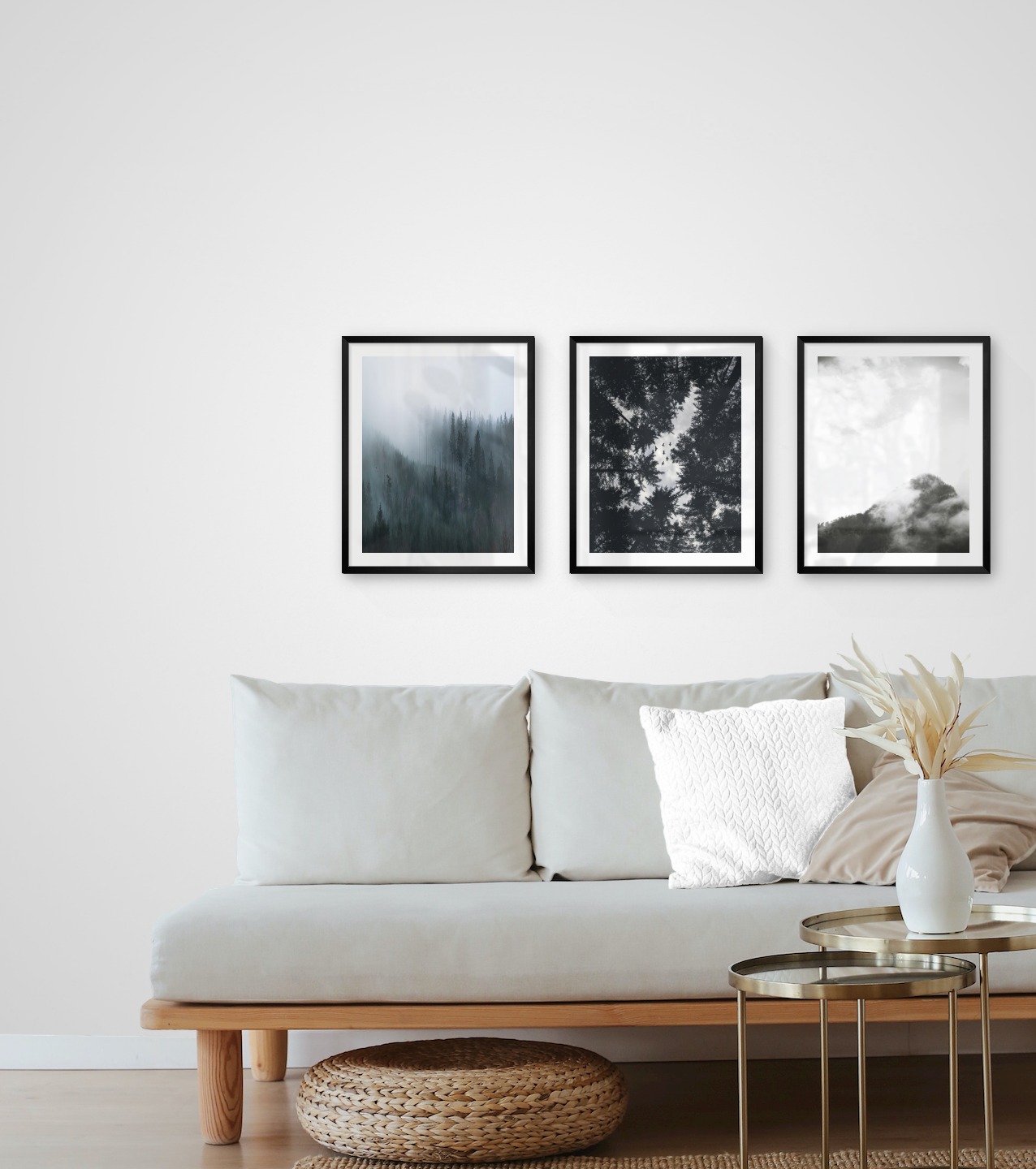 Gallery wall with picture frames in black in sizes 40x50 with prints "Foggy forest", "Wooden tops and birds" and "Trees and mountains in fog"