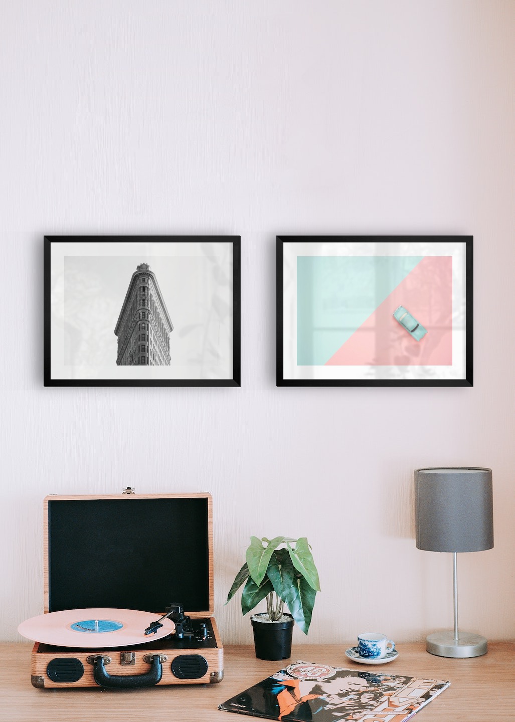 Gallery wall with picture frames in black in sizes 30x40 with prints "Triangular building" and "Blue car and pink"