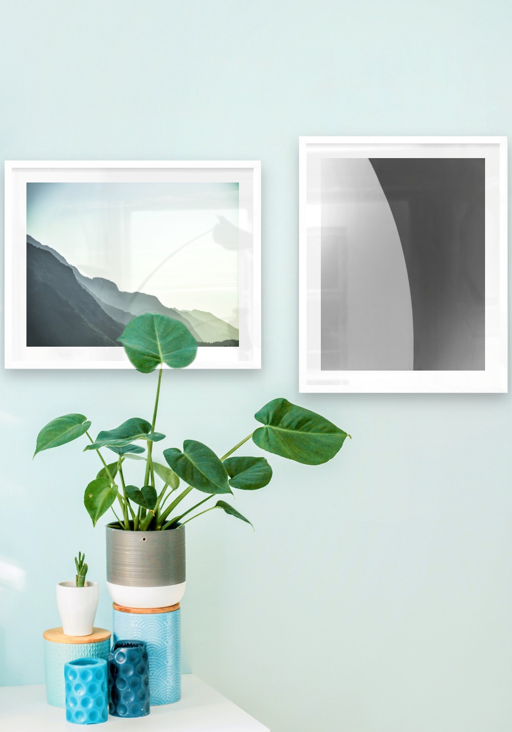 Gallery wall with picture frames in white in sizes 40x50 with prints "Foggy mountain" and "Line"