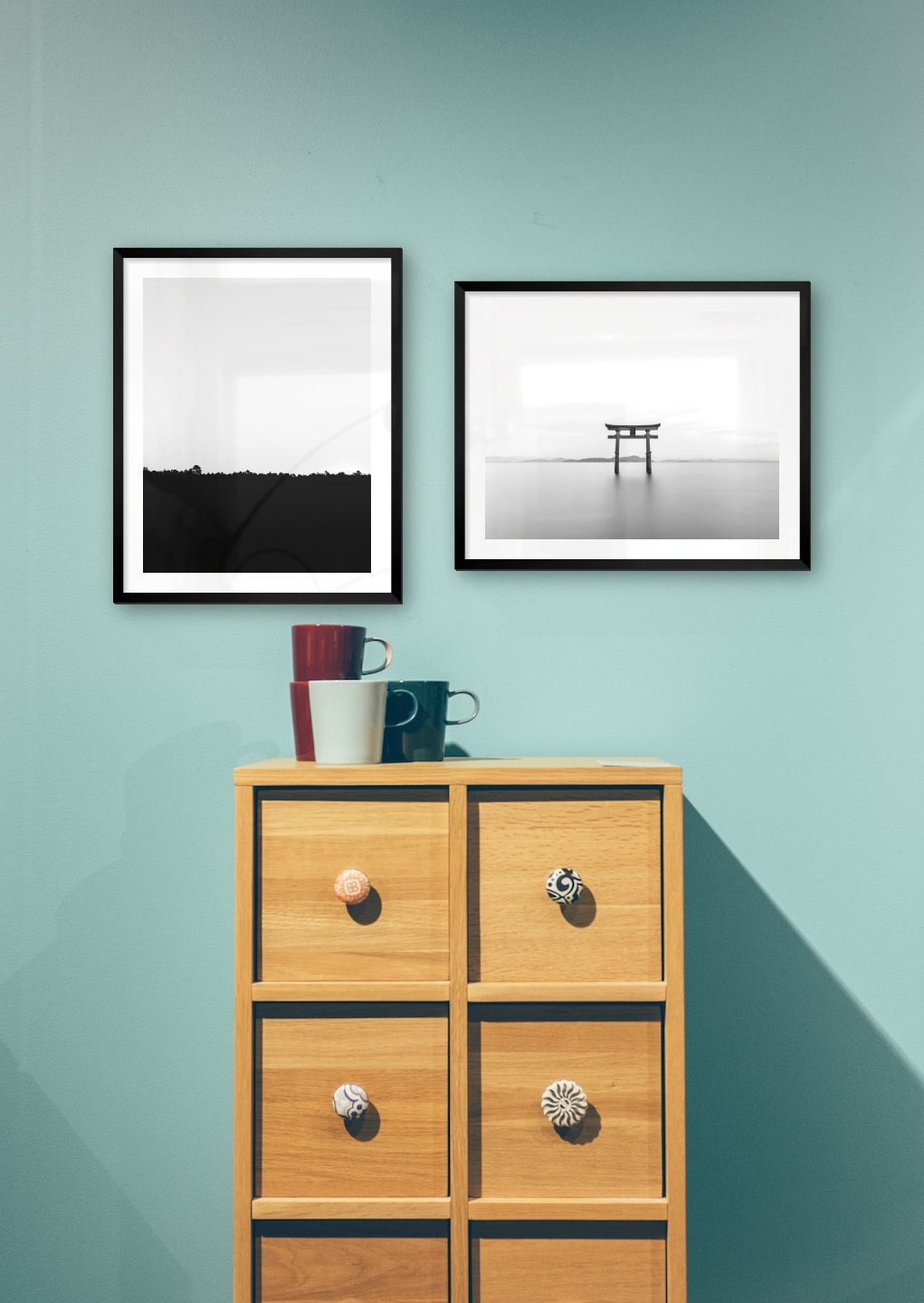 Gallery wall with picture frames in black in sizes 40x50 with prints "Sky above trees" and "Pillars in the water"