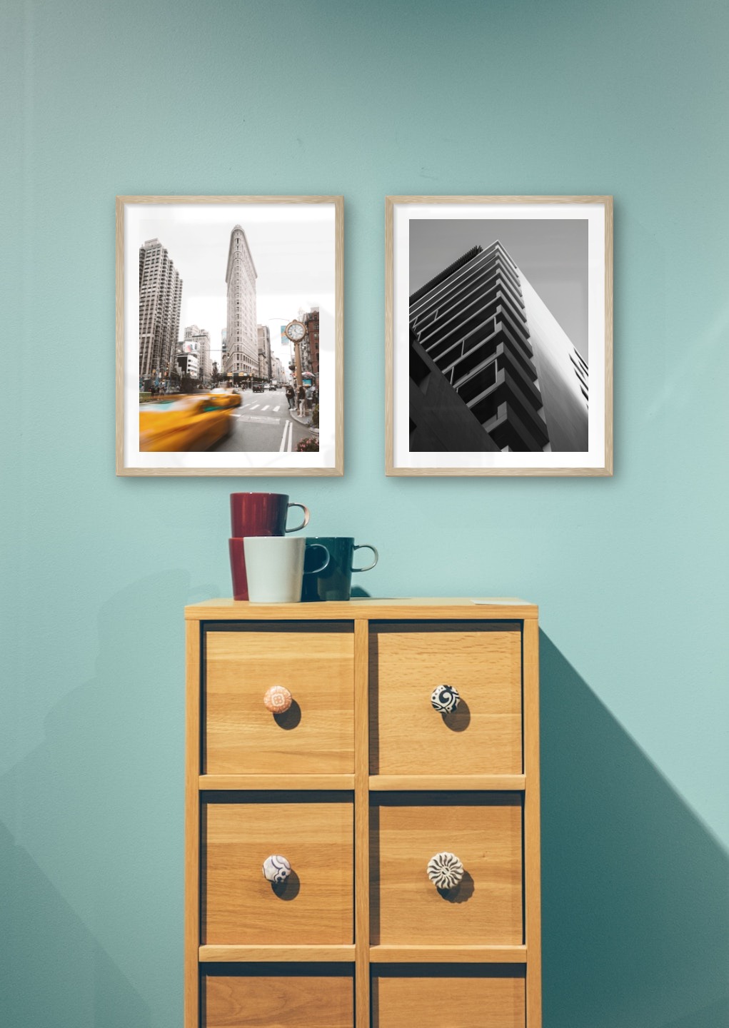 Gallery wall with picture frames in wood in sizes 40x50 with prints "Yellow taxis in town" and "Black and white building"
