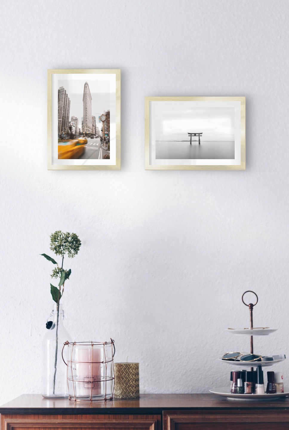 Gallery wall with picture frames in gold in sizes 21x30 with prints "Yellow taxis in town" and "Pillars in the water"