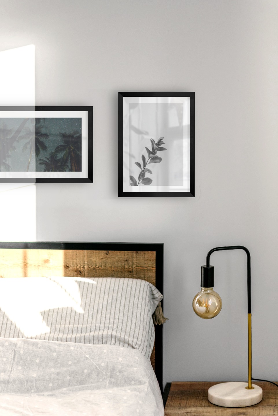 Gallery wall with picture frames in black in sizes 21x30 with prints "Palm trees and night sky" and "Twig"