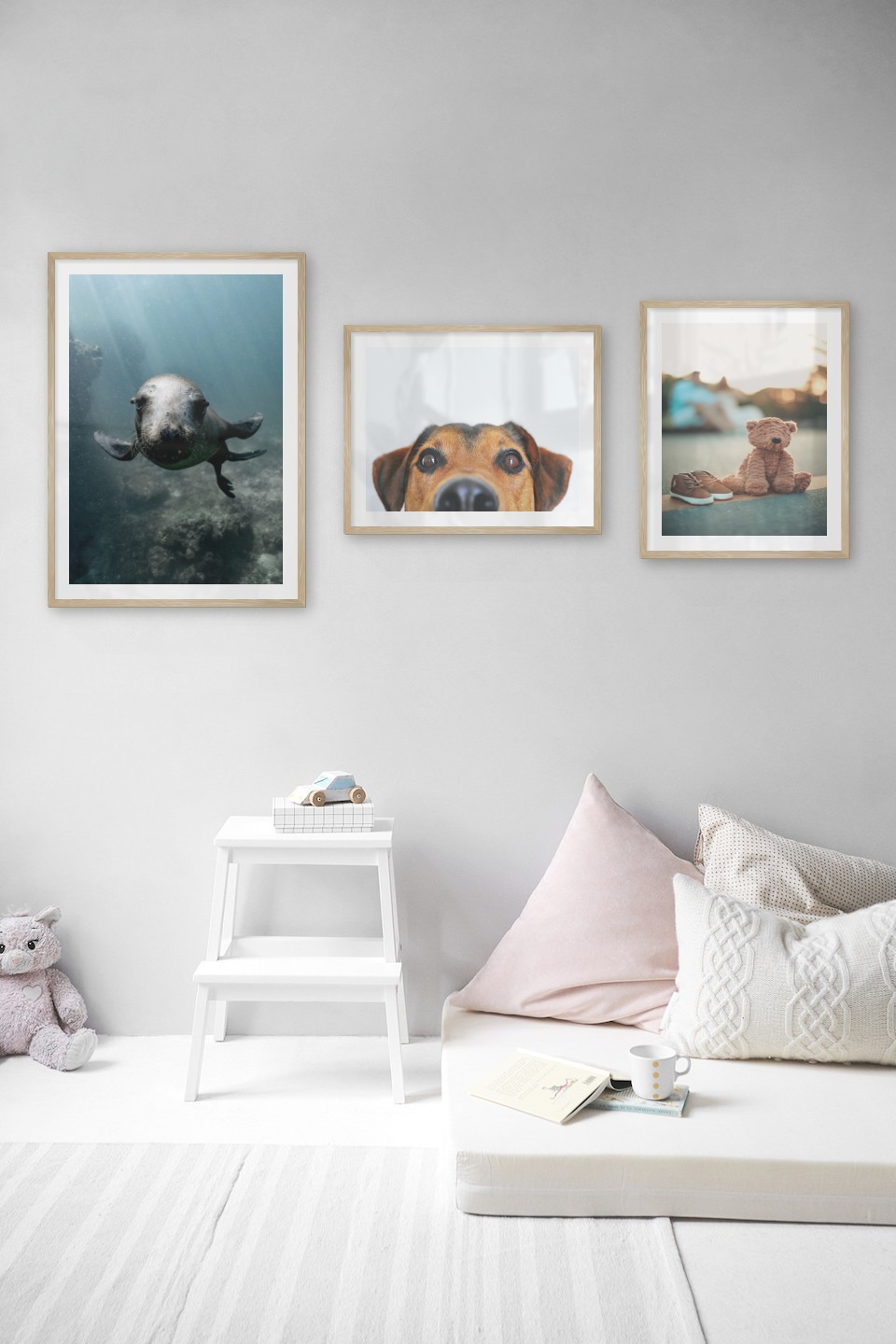 Gallery wall with picture frames in wood in sizes 50x70 and 40x50 with prints "Seal in the water", "Hundnos" and "Teddy bear on the street"