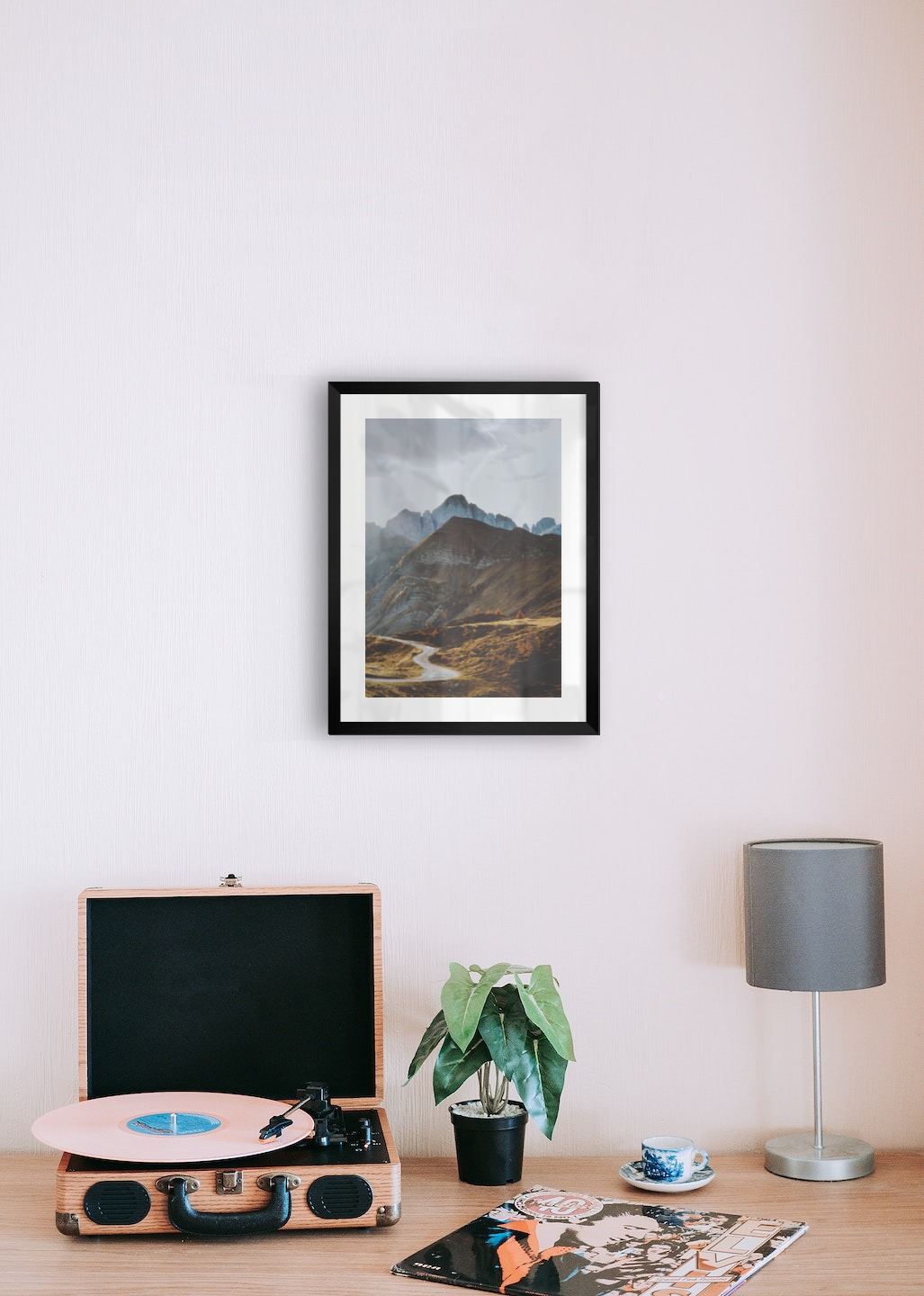 Gallery wall with picture frame in black in size 30x40 with print "Road among the mountains"