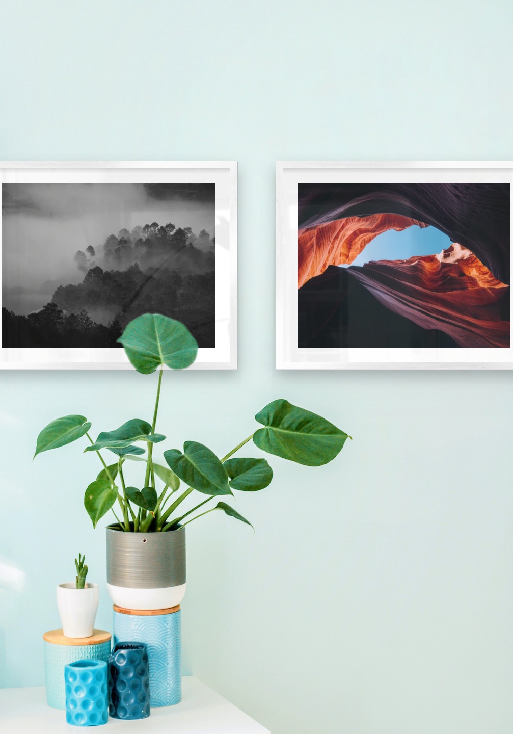 Gallery wall with picture frames in silver in sizes 40x50 with prints "Foggy wooden tops" and "Red rock formations"
