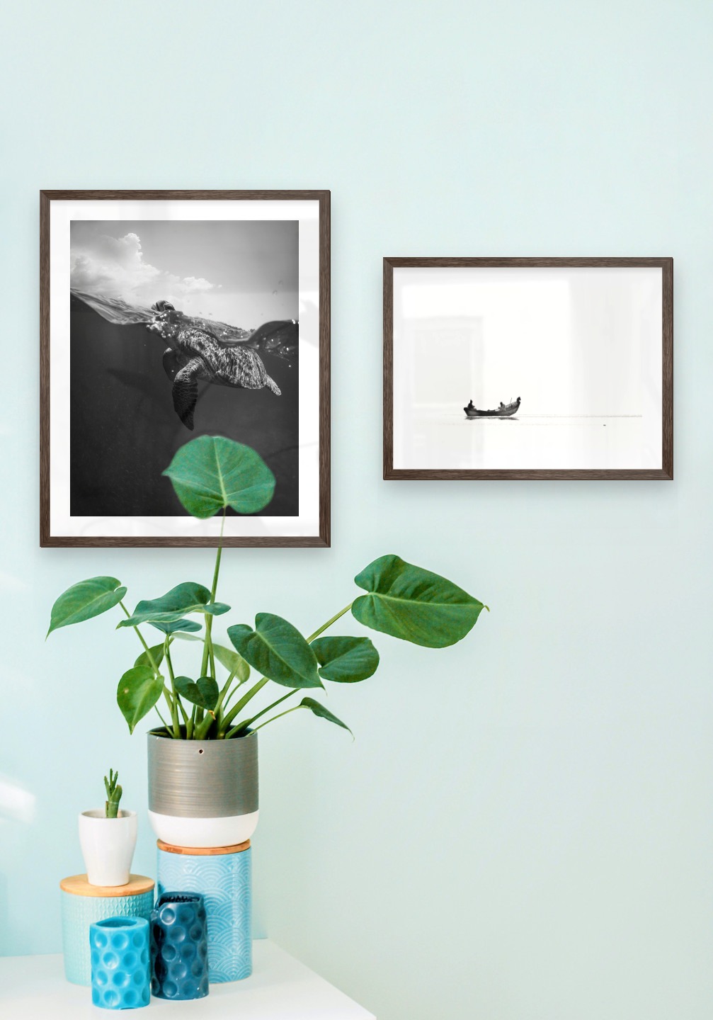 Gallery wall with picture frames in dark wood in sizes 40x50 and 30x40 with prints "Turtle" and "People in boat"