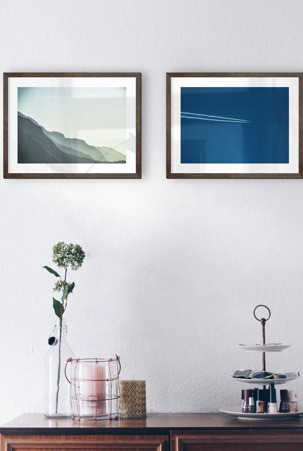 Gallery wall with picture frames in dark wood in sizes 30x40 with prints "Foggy mountain" and "Airplanes in the air"