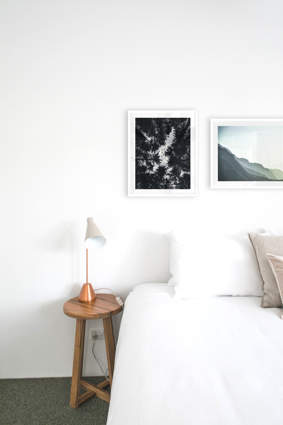 Gallery wall with picture frames in white in sizes 40x50 with prints "Wooden tops and birds" and "Foggy mountain"