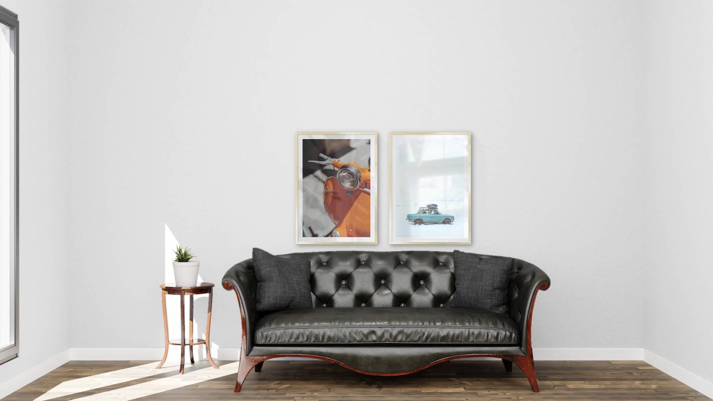 Gallery wall with picture frames in gold in sizes 50x70 with prints "Orange vespa" and "Car in snow"