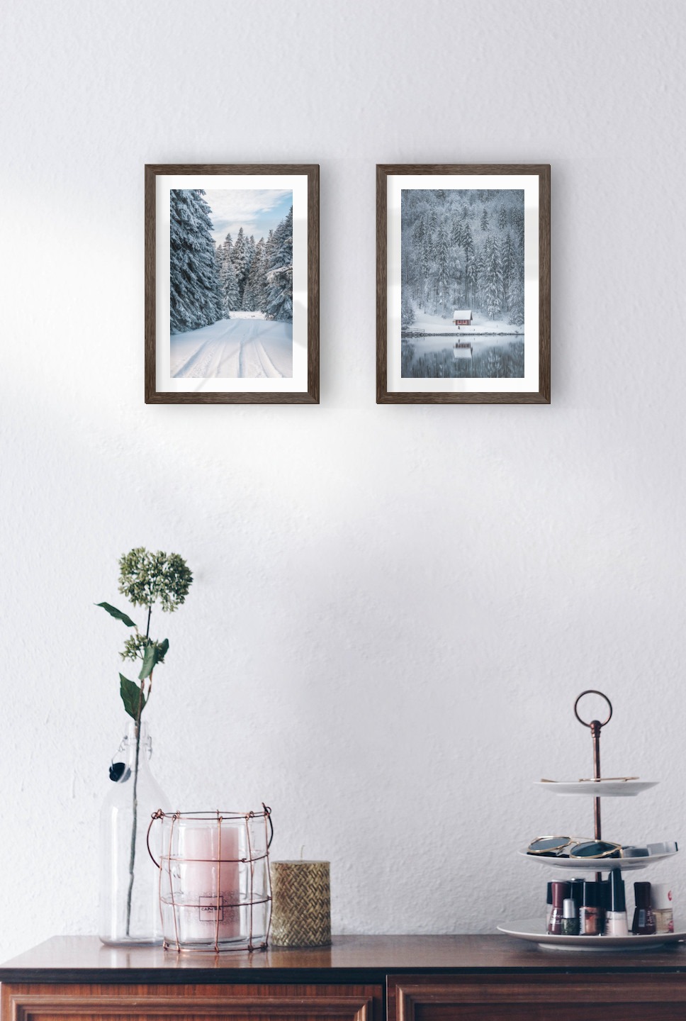 Gallery wall with picture frames in dark wood in sizes 21x30 with prints "Snowy road" and "Cottage by the lake"