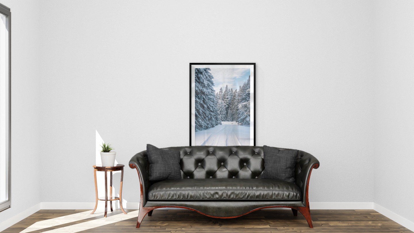 Gallery wall with picture frame in black in size 70x100 with print "Snowy road"